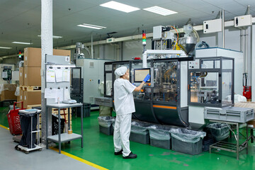 Woman operating machine at factory