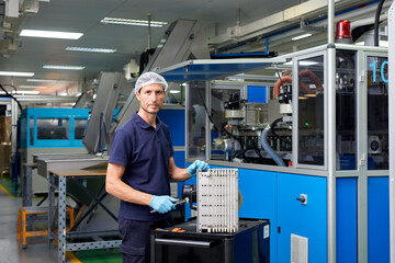 Mechanic fixing industrial machine at plant