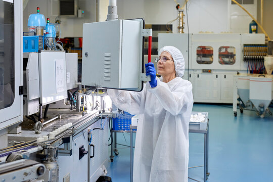 Woman operating conveyor at plant