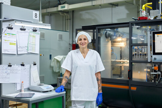 Smiling factory worker looking at camera