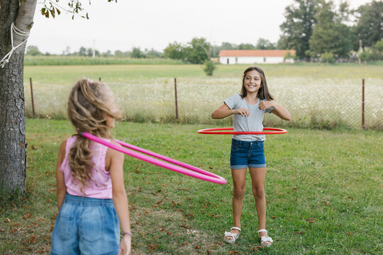 Young girls having fun with a hula hoops