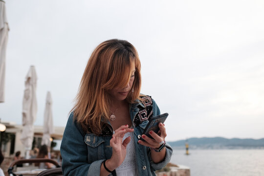 Young woman looking her mobile phone 