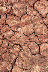 Red dry cracked ground. Dried clay texture and patterns cracked surface of clay and land.