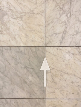 arrow on marble floor
