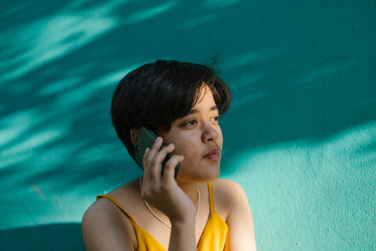 A South Asian teenager on a phone call