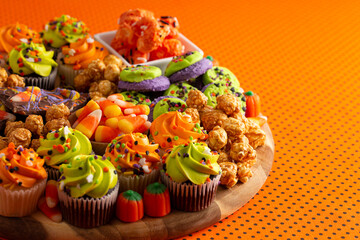 A Halloween Charcuterie Board on an Orange and Black Polkadot Background