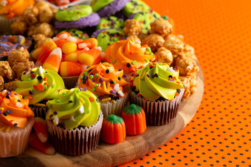 A Halloween Charcuterie Board on an Orange and Black Polkadot Background