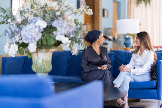 Two muslim friends talking and laughing