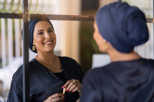 Modern islamic woman applying make up