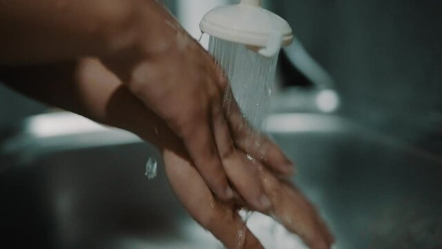 slow motion hand rubbing with soap  sanitizer  germ at home 