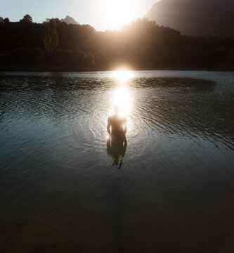 Lonely man standing in the water