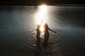 Lovers dancing in the water
