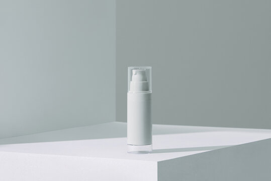 white cream cosmetic bottle on acrylic geometric pedestal podium block,