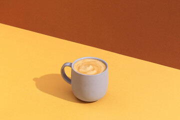 Cup of coffee on yellow table