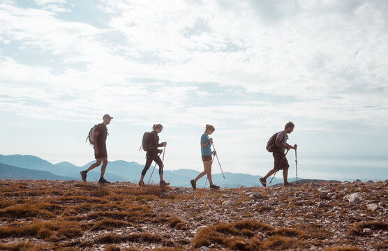 Four excursionists walking on the mountain