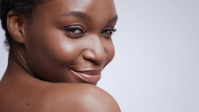 Dental aesthetics. Young beautiful african american lady with dental braces smiling to camera, empty space, slow motion