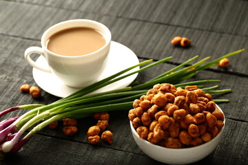 Homemade roasted and spices coated  organic peanuts served with  Indian milk tea.