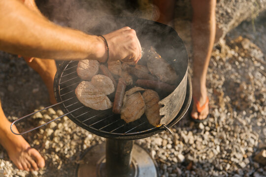 Friends preparing barbecue at the beach