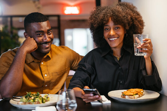 Positive black couple having lunch