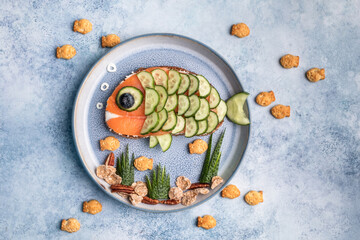 Funny salmon fish sandwich with cucumber for kids lunch