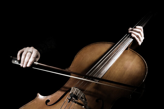 Cello player. Cellist hands playing cello with bow