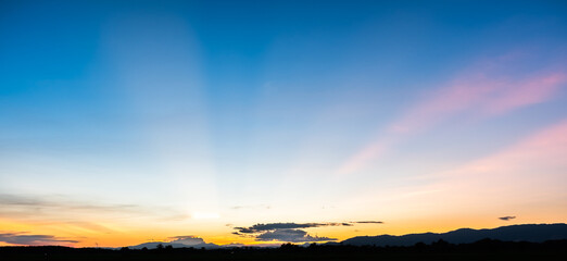Colorful sunset and sunrise with clouds.Blue and orange color of nature.Many white clouds in the blue sky.The weather is clear today.sunset in the clouds.The sky is twilight.