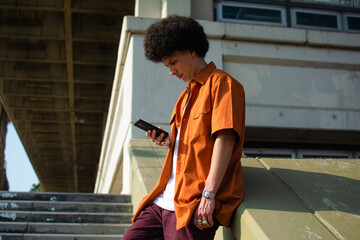 Man with afro checking his phone