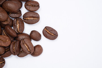 Obraz premium Bean coffee in white background. Medium roasted coffee beans are light brown in color in white background with copy space.