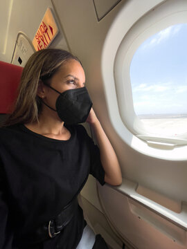 Traveler in mask in plane cabin