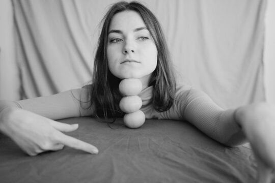 Woman Leaning Her Face On Mandarins 