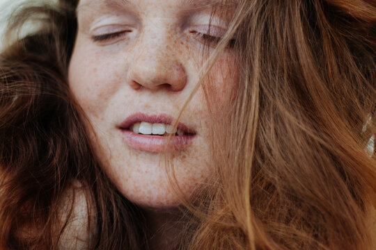 Tender red hair young woman with freckles