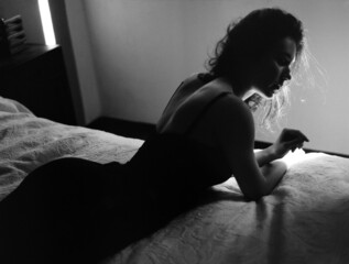 A silhouette of a woman in bedroom 