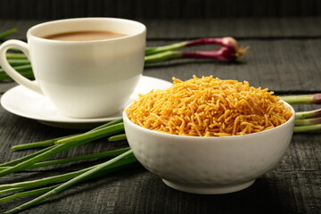 Indian tea time, namkeen, mixture snack served with cup of milk tea.
