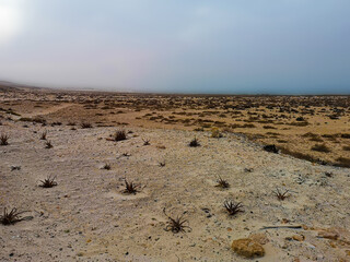 Colorful sky over a dry desert, Espingueira, Cape Verde. Hot February day on a tropical African Island. Selective focus on the horizon, blurred background.