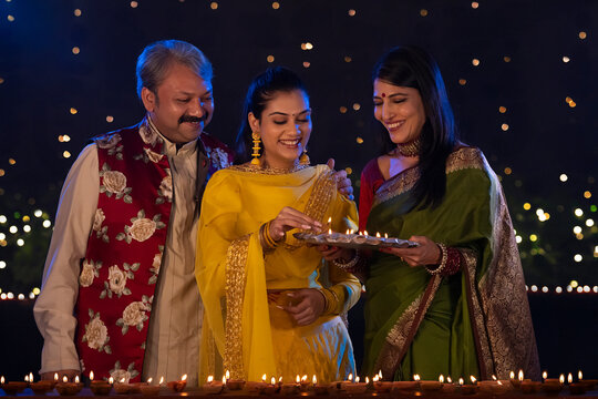 Parents with their daughter enjoying and celebrating Diwali together