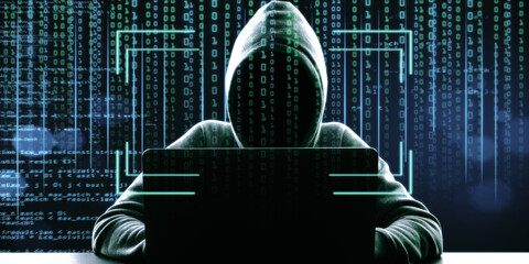 Hacker in hoodie using laptop at desktop on abstract binary code background with face recognition interface. Hacking, ID and innovation concept. Double exposure.
