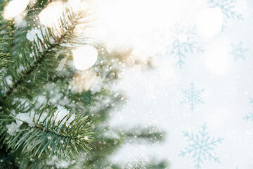 Closeup of Christmas tree with sparkling light, snowflake. Christmas and New Year holiday background..