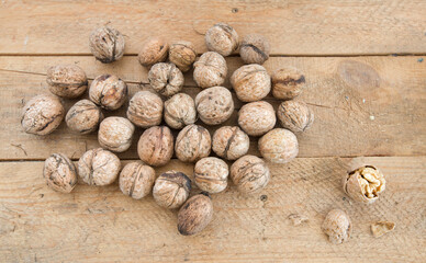 Mature walnuts on a table made of rough planks