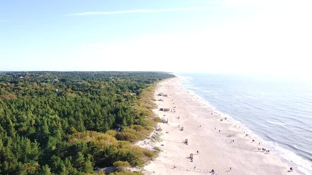 Sandy beach of Palanga with pine tree forest and Baltic sea, aerial descend view