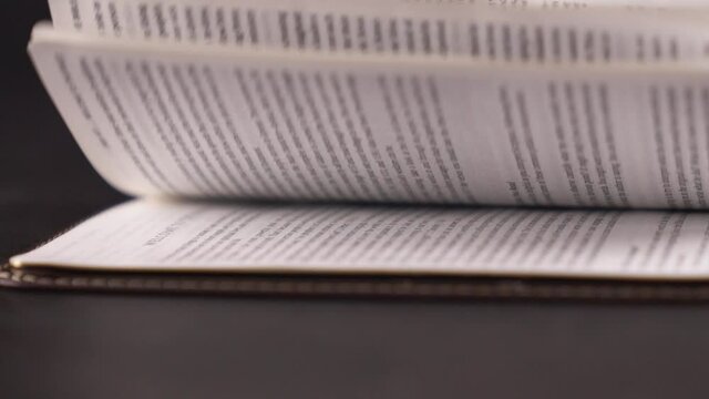 Bible pages turning very fast in slow motion from the side Full HD Slow Motion