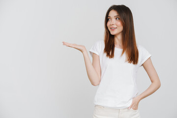 Young ginger woman in t-shirt smiling and holding copyspace