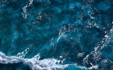 Aerial view to seething waves with foam. Waves of the sea meet each other during high tide and low tide - 463761126