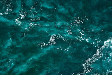 Aerial view to seething waves with foam. Waves of the sea meet each other during high tide and low tide - 463761135