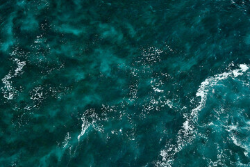 Aerial view to seething waves with foam. Waves of the sea meet each other during high tide and low tide - 463761137