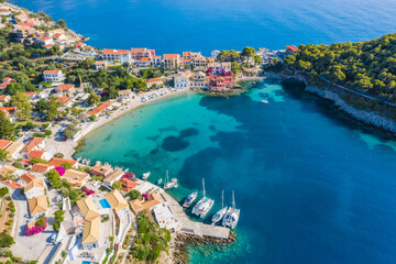 Fototapeta na wymiar Assos picturesque fishing village from above, Kefalonia, Greece. Aerial drone view. Sailing boats moored in turquoise bay