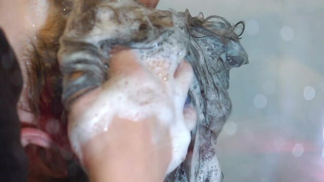 Woman washes her hair in slow motion 120fps