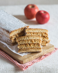 Layered russian apple pastille marshmallow on paper on a board, red apples in background. Selective focus. Vegan food