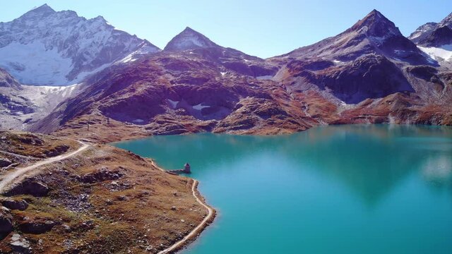 Picturesque Landscape Of Mountain And Tranquil Blue Waters Of Weisssee Lake And Reservoir In Summer In Austria. - aerial