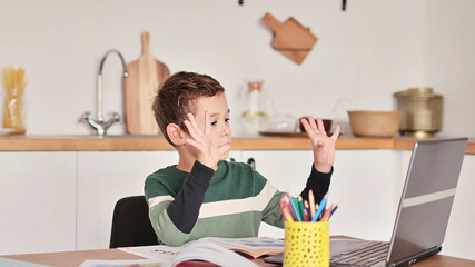 Smart boy student listen to online lesson on tablet wear headphones Spbas. Homeschooled child watch.