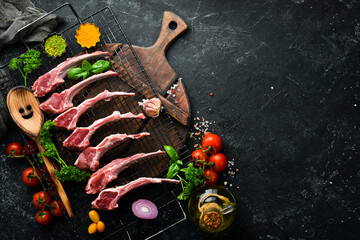 Fresh raw lamb ribs on a dark kitchen table. Rustic style. Photo for the catalog.